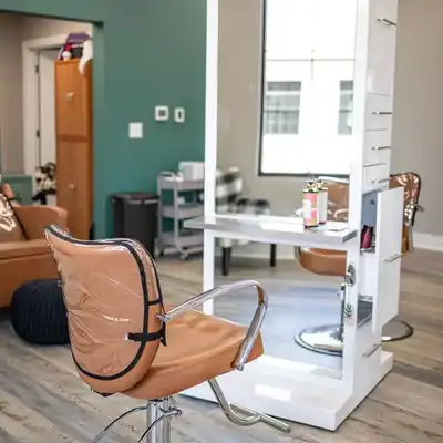 JAM Beauty Bar styling station with chair, mirror, and salon workspace